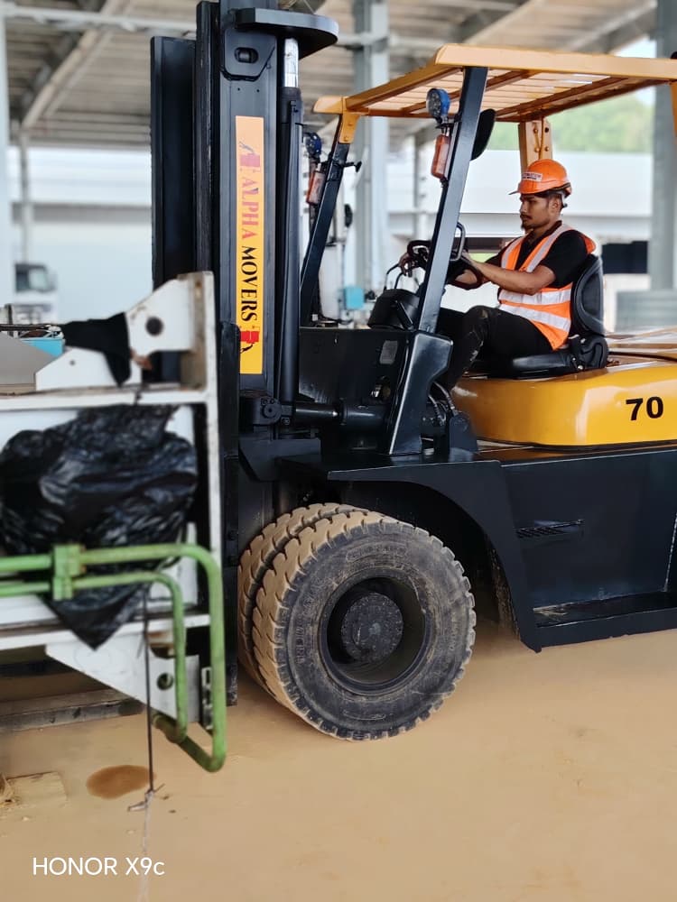 Alpha Movers forklift with an operator handling a load on site